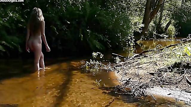 Adorable, blonde girl got naked in the nature and started touching herself in a naughty way